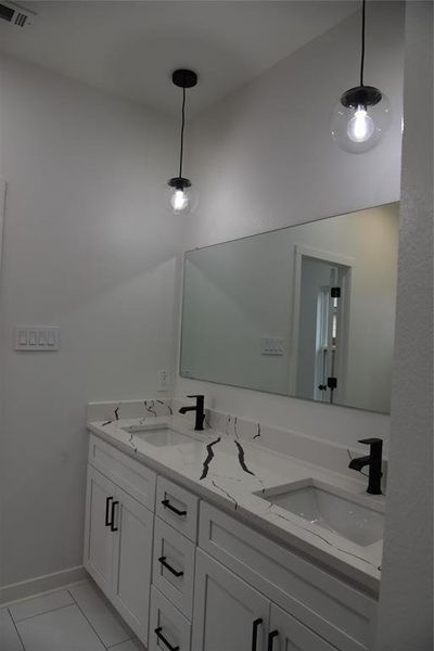 Bathroom with tile patterned floors and vanity