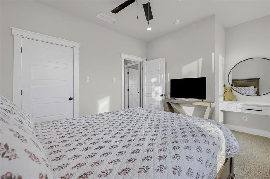 Carpeted bedroom with ceiling fan