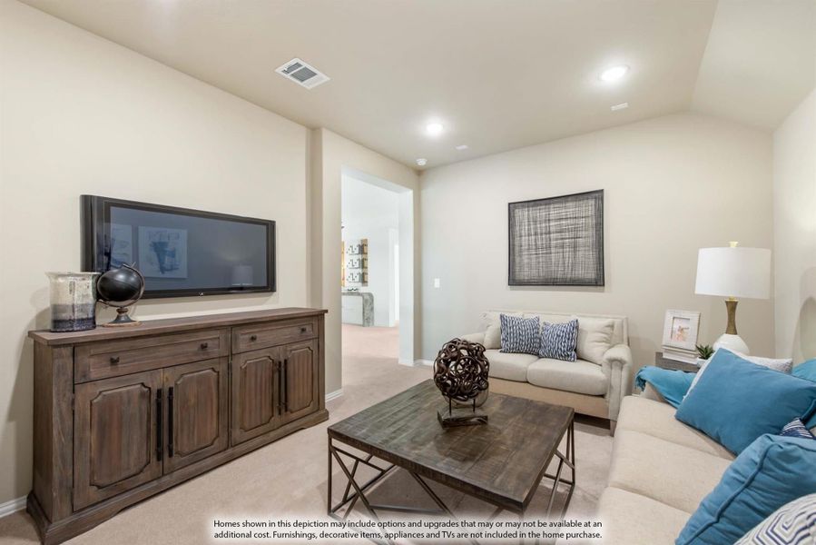 Living room with wall-mounted TV, wood media console, neutral sofa, and carpeted floors