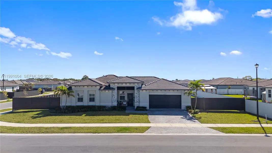 Front exterior of a new home in , Homestead, FL, highlighting curb appeal (Image 22).