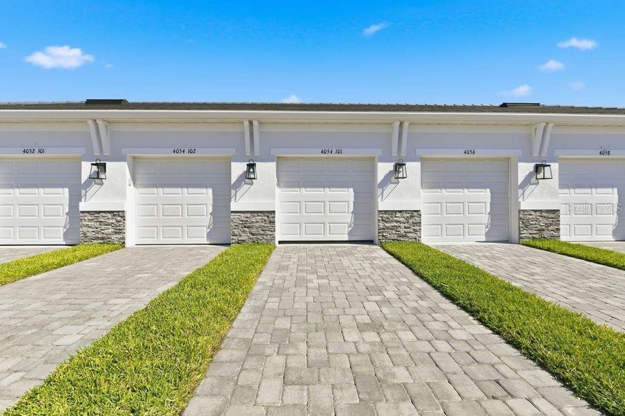 Front exterior of a new home in Esplanade at Azario Lakewood Ranch, Bradenton, FL, highlighting curb appeal (Image 2).