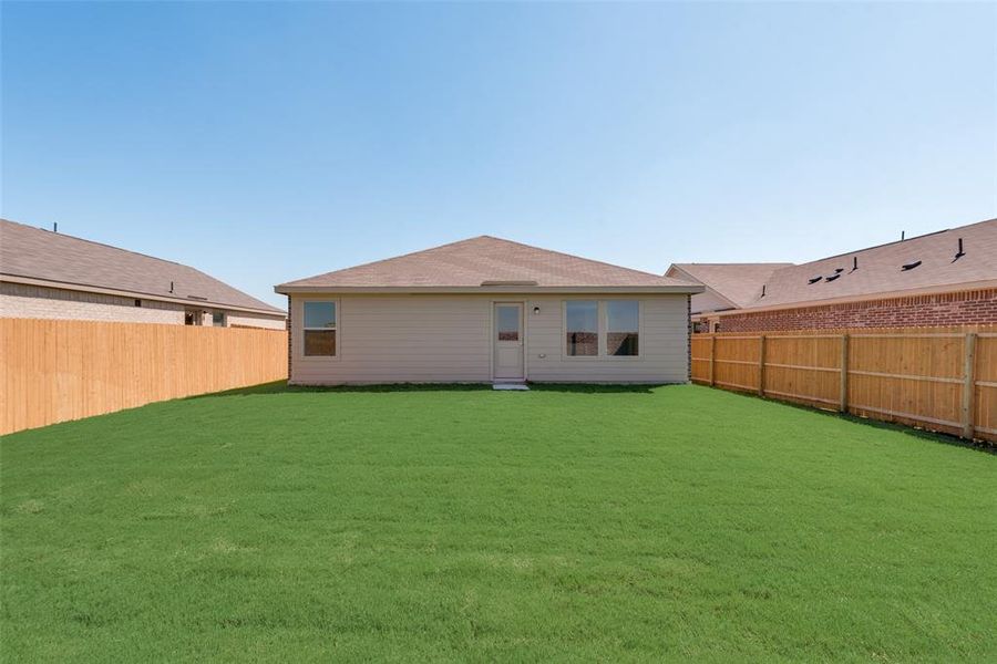 Back of house featuring a lawn