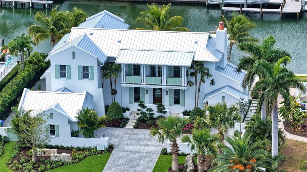 Front exterior of a new home in , Longboat Key, FL, highlighting curb appeal (Image 1). Front exterior of a new home in , Longboat Key, FL, highlighting curb appeal (Image 1).