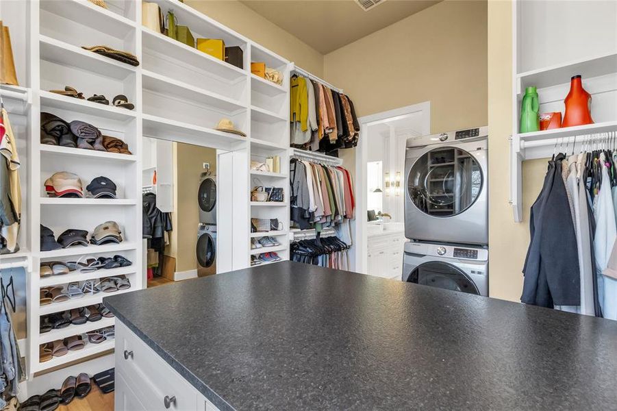 Laundry area within primary closet and island