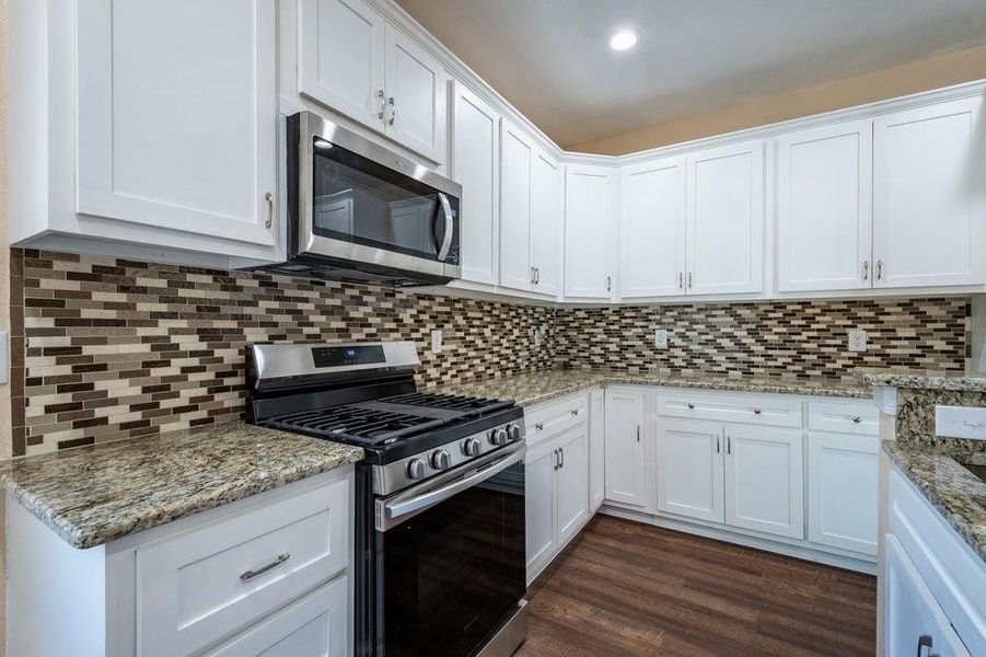 Custom glass back splash and gas range.