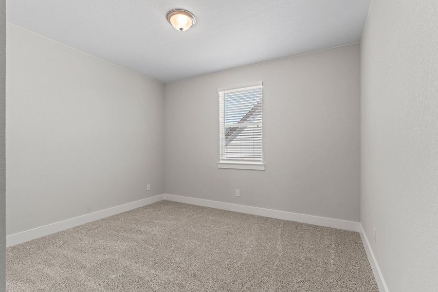 Spare room featuring light colored carpet and baseboards Spare room featuring light colored carpet and baseboards