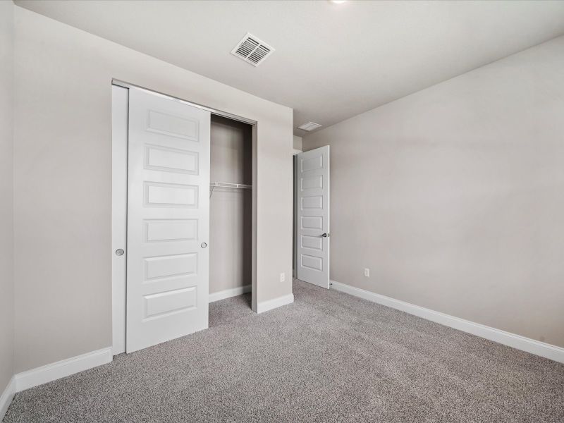 Bedroom in the Coral floorplan at 6326 NW Sweetwood Drive in Brystol at Wylder