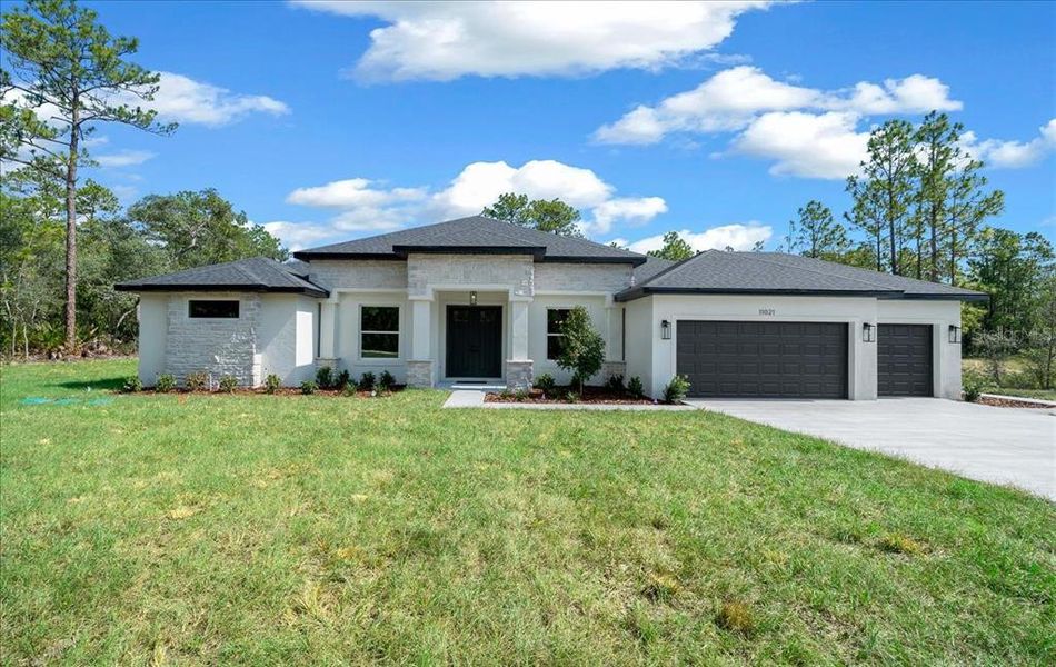 Front exterior of a new home in , Weeki Wachee, FL, highlighting curb appeal (Image 38). Front exterior of a new home in , Weeki Wachee, FL, highlighting curb appeal (Image 38).