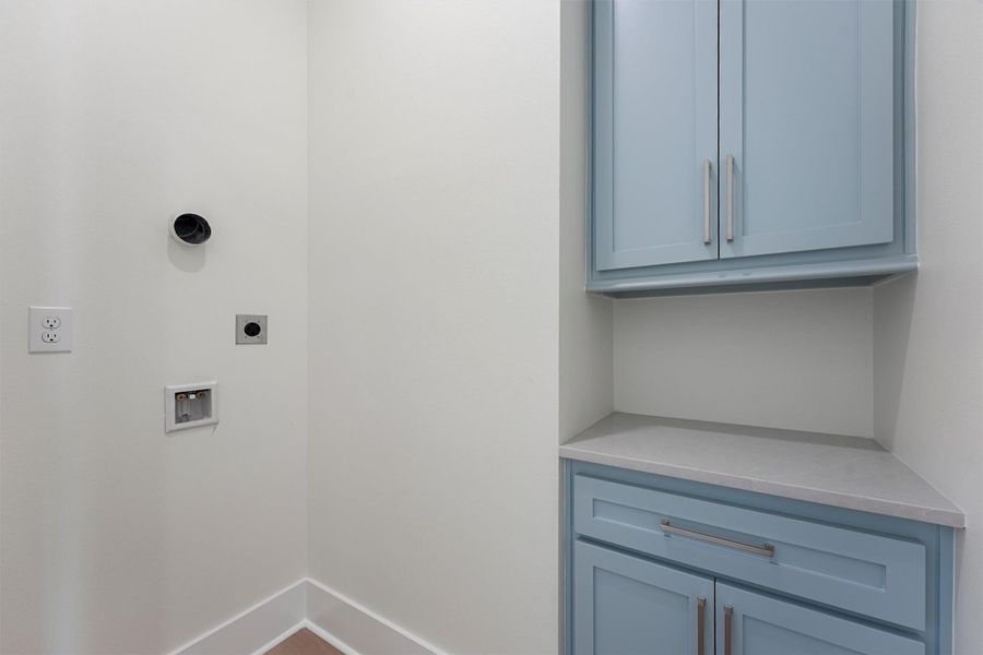 A dedicated laundry space with upper and lower cabinetry keeps everything organized and out of sight. A dedicated laundry space with upper and lower cabinetry keeps everything organized and out of sight.