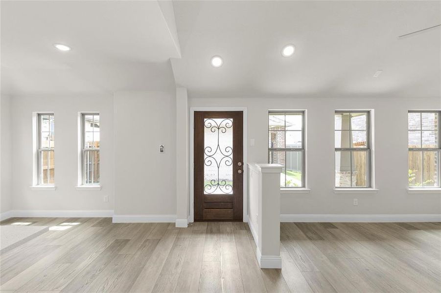 Foyer entrance featuring light hardwood / wood-style floors