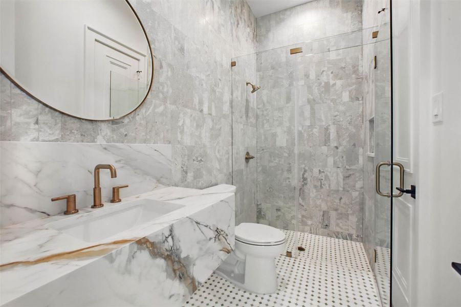 Sample of builder's previous construction. This home will have a downstairs full bath for guests to access adjacent to the study/optional 6th bedroom. Buyer still has time to select finishes.