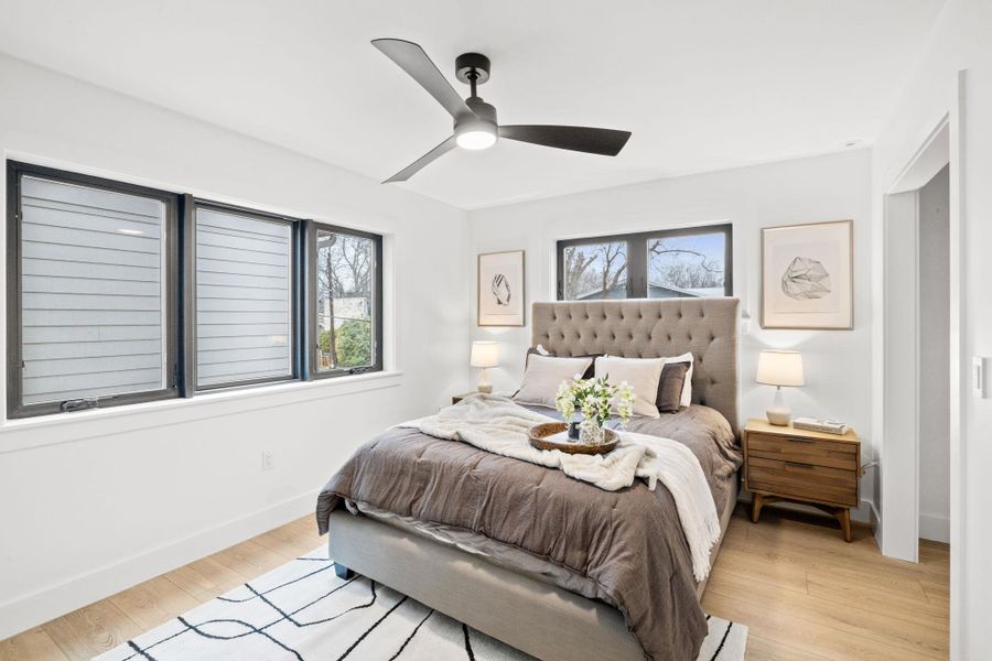 Bedroom featuring light wood-style flooring, baseboards, and ceiling fan