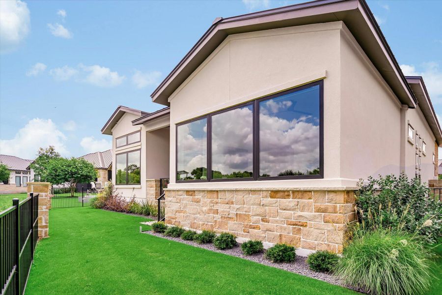 Clean lines and a modern facade define this sophisticated residence with ample windows.