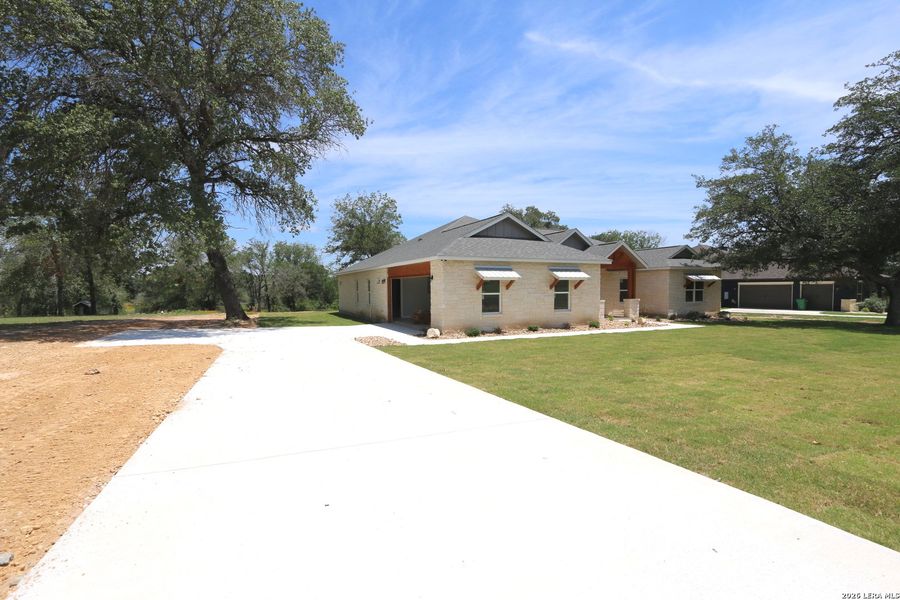 Front exterior of a new home in , La Vernia, TX, highlighting curb appeal (Image 15). Front exterior of a new home in , La Vernia, TX, highlighting curb appeal (Image 15).