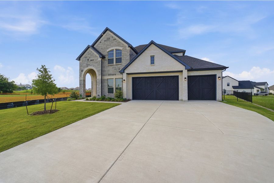 Front exterior of a new home in Heath Golf & Yacht Club, Heath, TX, highlighting curb appeal (Image 26). Front exterior of a new home in Heath Golf & Yacht Club, Heath, TX, highlighting curb appeal (Image 26).