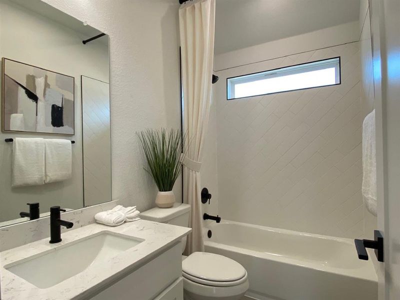 Laundry room with sink, closet under the stairs, and door to primary closet