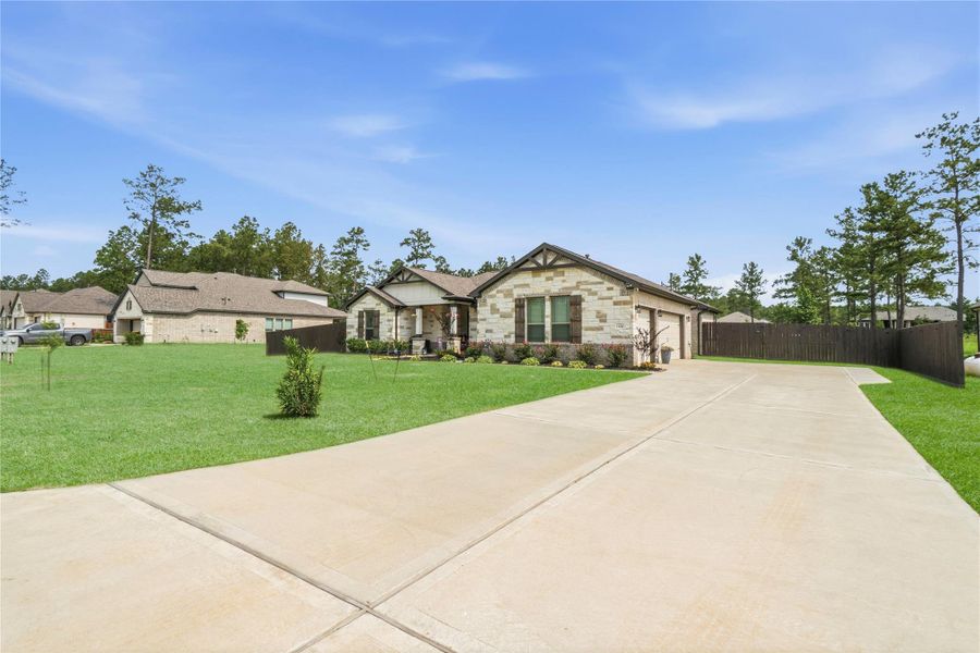 This beautifully maintained home offers striking curb appeal with manicured landscaping, stone accents, and an oversized driveway with plenty of parking.