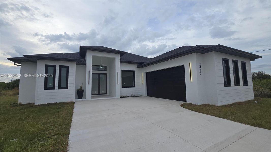Front exterior of a new home in , Lehigh Acres, FL, highlighting curb appeal (Image 25).