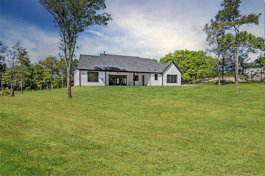 Back of property featuring a yard and a patio area Back of property featuring a yard and a patio area