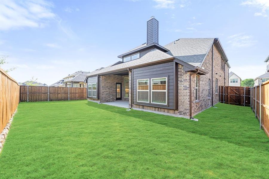 Exterior details and patio area of a home in Woodstone, Providence Village (Image 2).