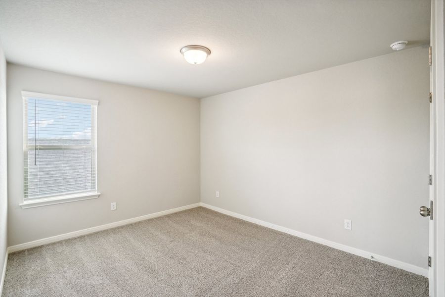 Guest bedroom of the Reynolds floorplan at a Meritage Homes community.