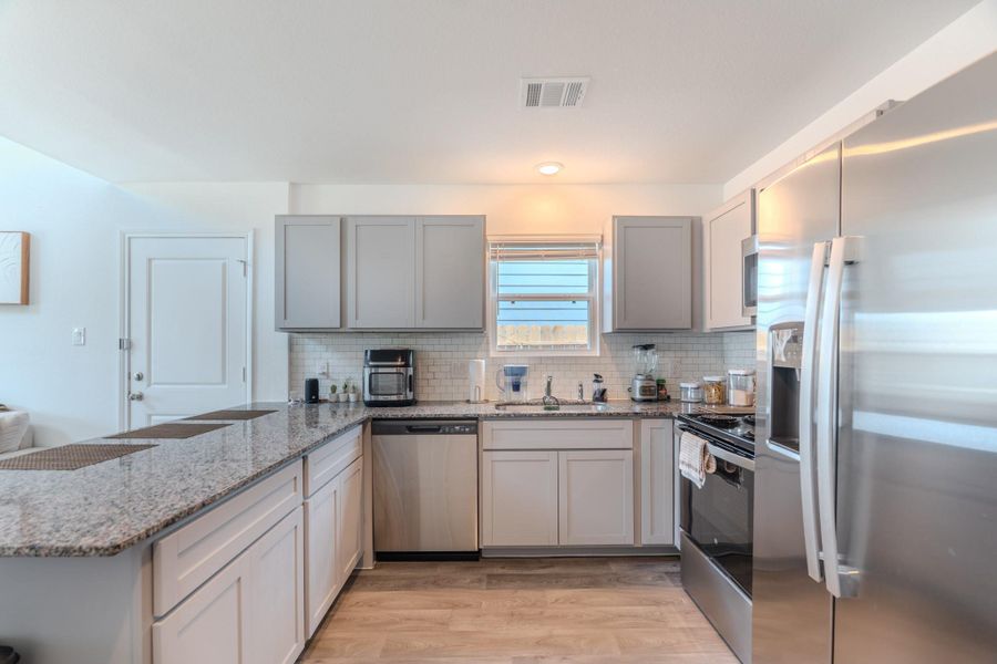 Stainless steel appliances and sleek cabinetry in contemporary kitchen Stainless steel appliances and sleek cabinetry in contemporary kitchen