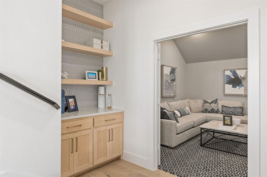 Living room with light wood finished floors and baseboards Living room with light wood finished floors and baseboards