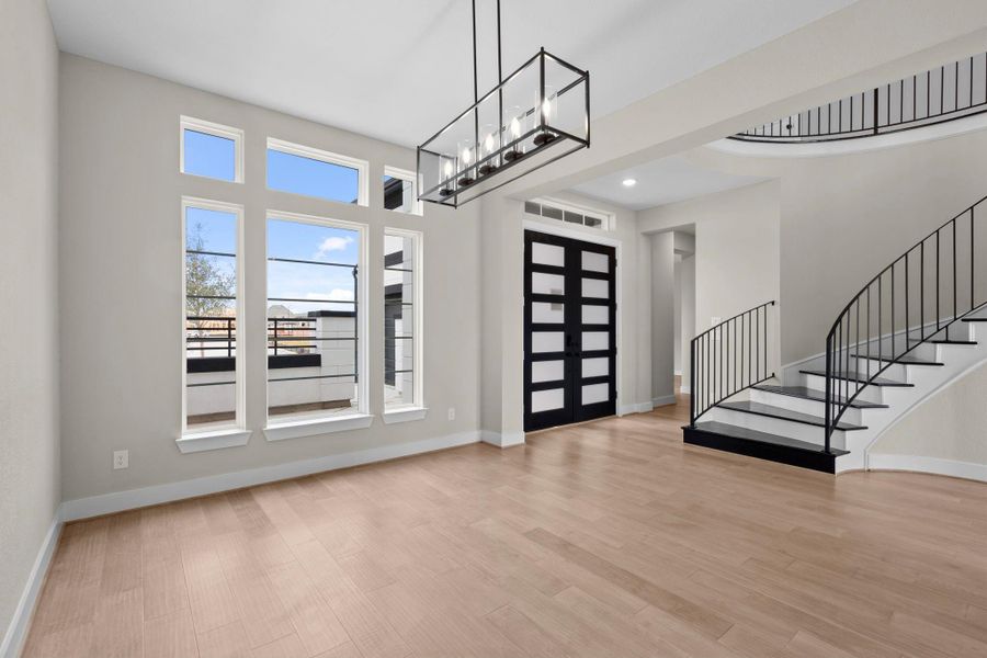 Bright and airy dining room overlooks the front courtyard