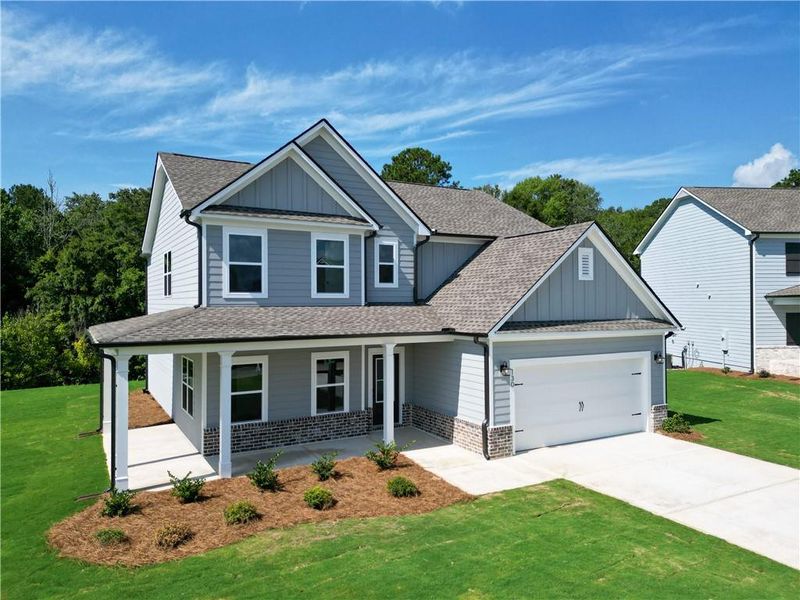 Front exterior of a new home in Harmony Farms, Eatonton, GA, highlighting curb appeal (Image 2). Front exterior of a new home in Harmony Farms, Eatonton, GA, highlighting curb appeal (Image 2).