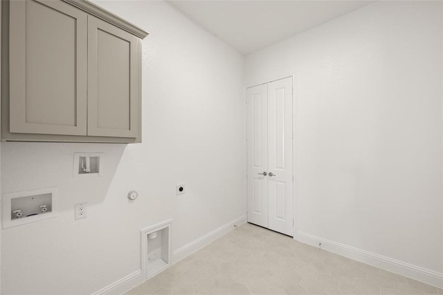 Washroom with gas dryer hookup, cabinet space, electric dryer hookup, washer hookup, and baseboards Washroom with gas dryer hookup, cabinet space, electric dryer hookup, washer hookup, and baseboards