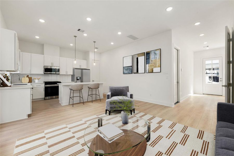 The open concept living space connects the living, dining, and kitchen areas—perfect for both everyday living and entertaining! *Virtually Staged