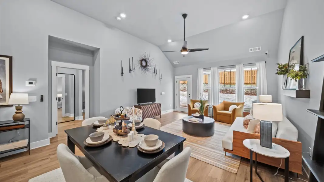 Spacious and stylish family room with two-story ceilings that create a bright and open atmosphere Spacious and stylish family room with two-story ceilings that create a bright and open atmosphere