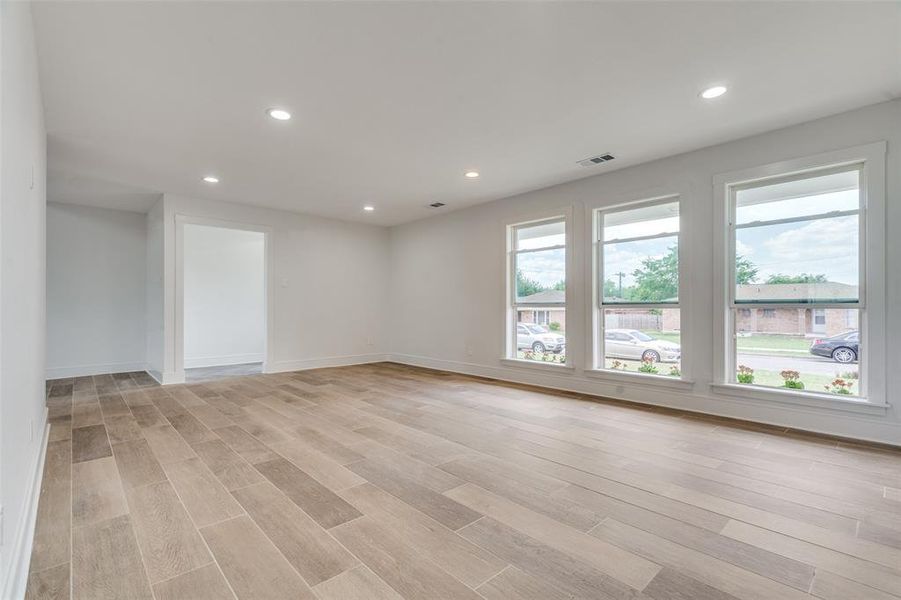 Empty room with light hardwood / wood-style floors