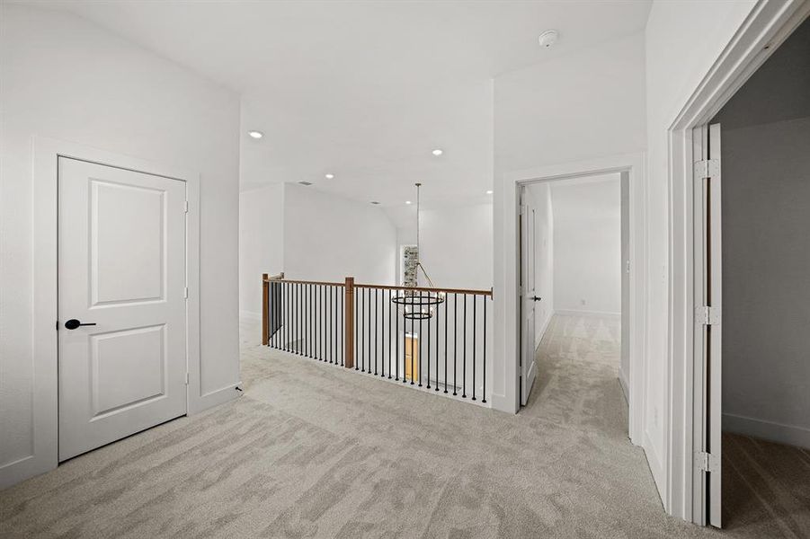 Corridor featuring recessed lighting and light carpet