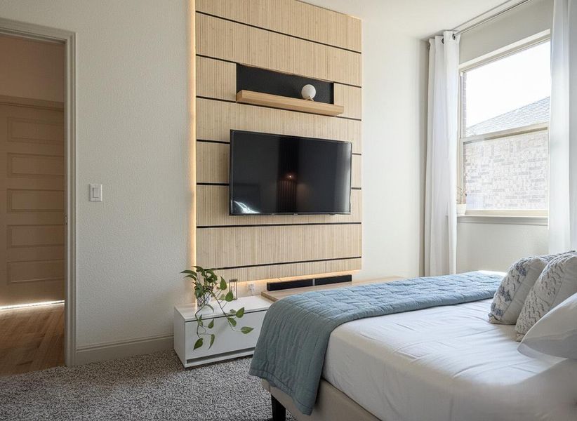 Carpeted bedroom with baseboards