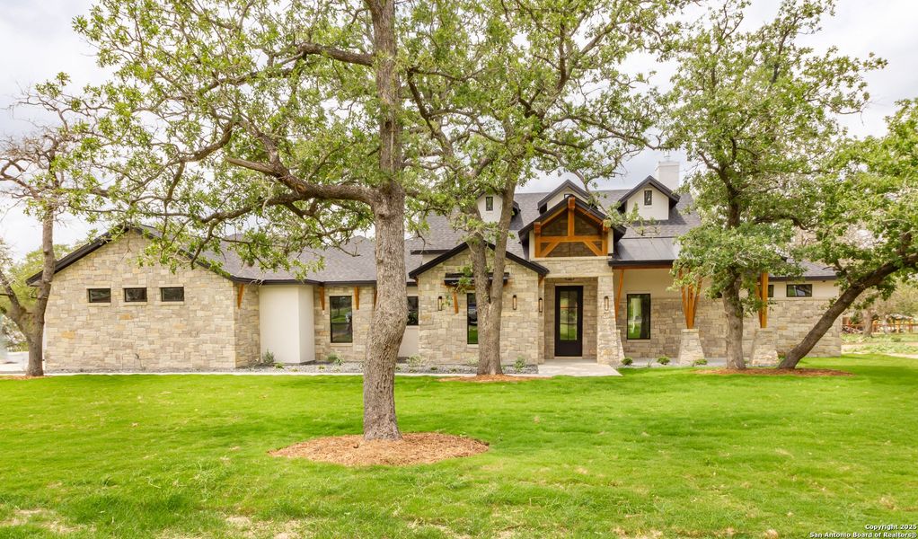 Front exterior of a new home in , La Vernia, TX, highlighting curb appeal (Image 24).