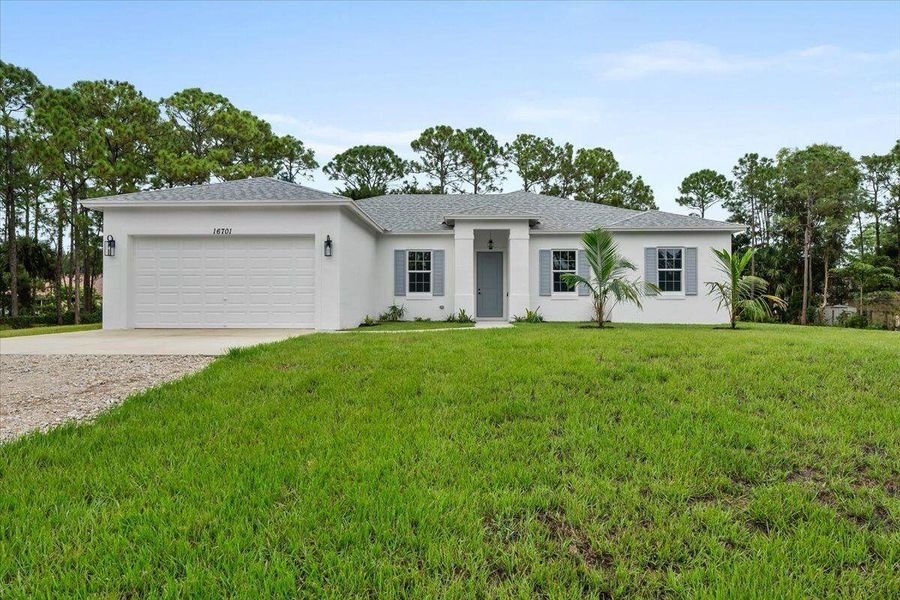 Front exterior of a new home in , Loxahatchee, FL, highlighting curb appeal (Image 1). Front exterior of a new home in , Loxahatchee, FL, highlighting curb appeal (Image 1).