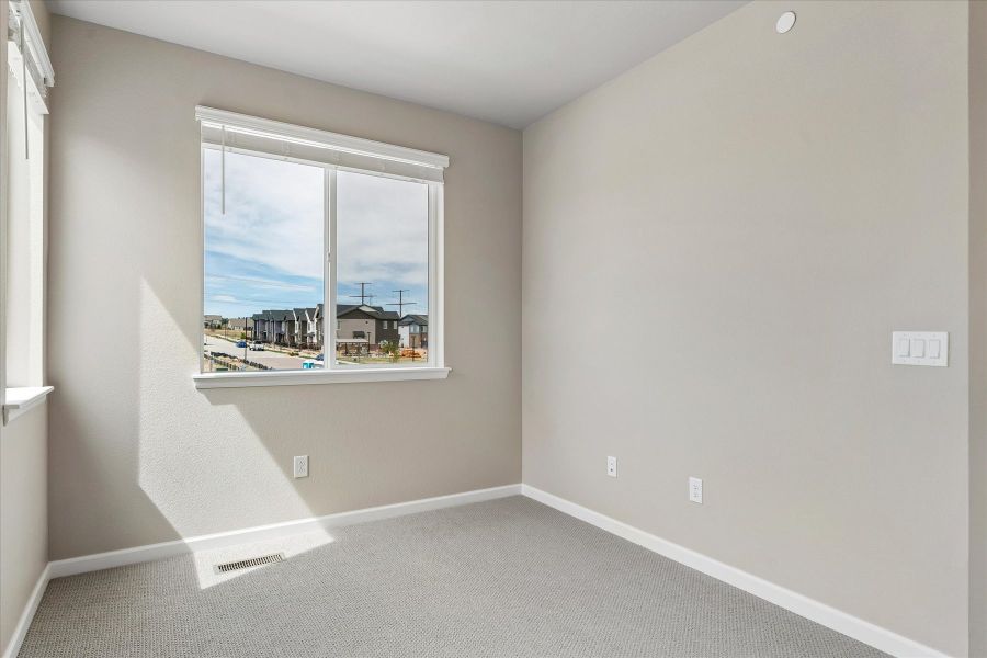 A room with a window and a view of the city.