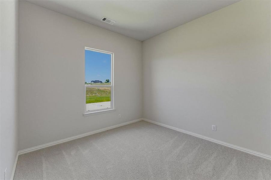 Room with light gray wall paint, white baseboards, and carpeted flooring