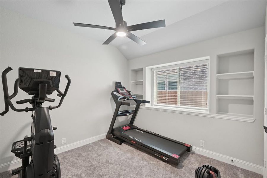 Exercise room with built in features, ceiling fan, carpet, and vaulted ceiling Exercise room with built in features, ceiling fan, carpet, and vaulted ceiling