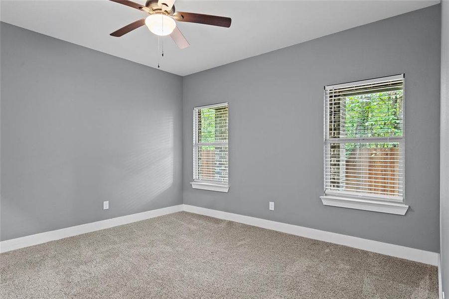 Spare room featuring carpet and ceiling fan Spare room featuring carpet and ceiling fan