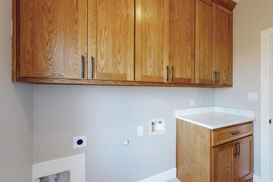 Laundry room featuring cabinets, hookup for an electric dryer, and washer hookup