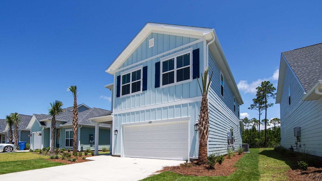 Front exterior of a new home in Breakfast Point East Phase I, Panama City Beach, FL, highlighting curb appeal (Image 21).