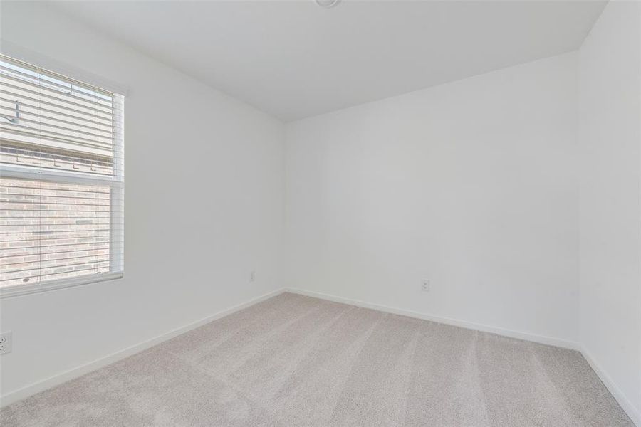 Unfurnished room featuring light colored carpet