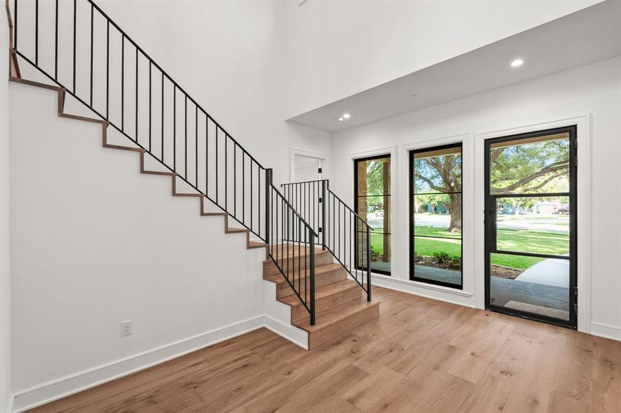 Foyer featuring stairs, light wood-type flooring, and recessed lighting Foyer featuring stairs, light wood-type flooring, and recessed lighting