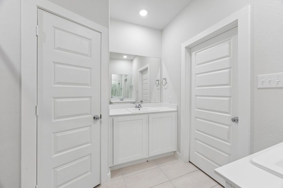 Primary Bathroom in the Cedar home plan by Trophy Signature Homes – REPRESENTATIVE PHOTO
