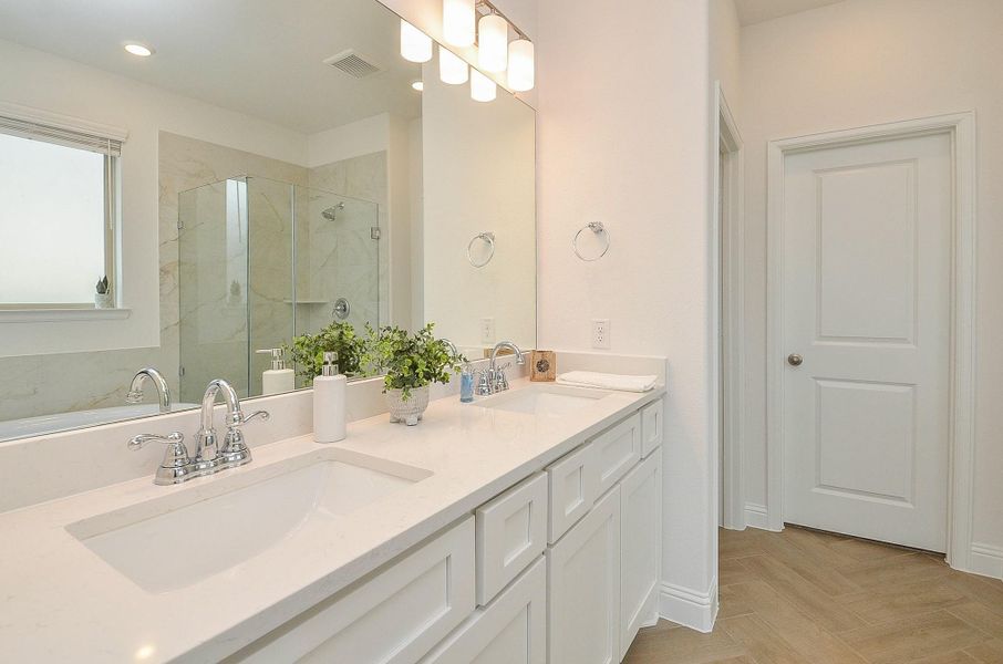 Double vanities in this light bright primary bathroom.