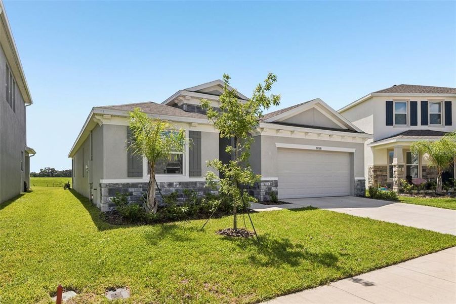 Front exterior of a new home in , Wesley Chapel, FL, highlighting curb appeal (Image 23). Front exterior of a new home in , Wesley Chapel, FL, highlighting curb appeal (Image 23).