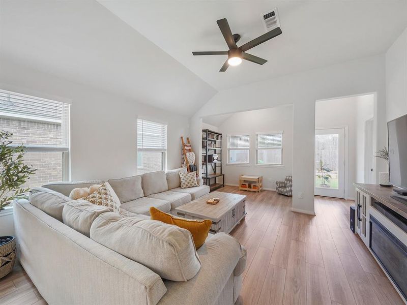 Enter into the living room with high ceilings, beautiful flooring and a reading nook!