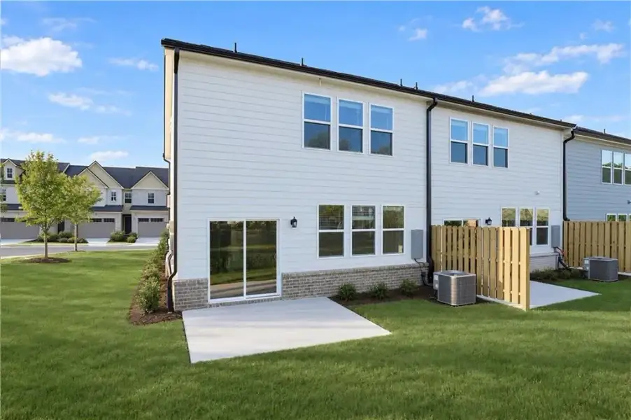 Exterior details and patio area of a home in Towns at Holly Springs, Holly Springs (Image 18).
